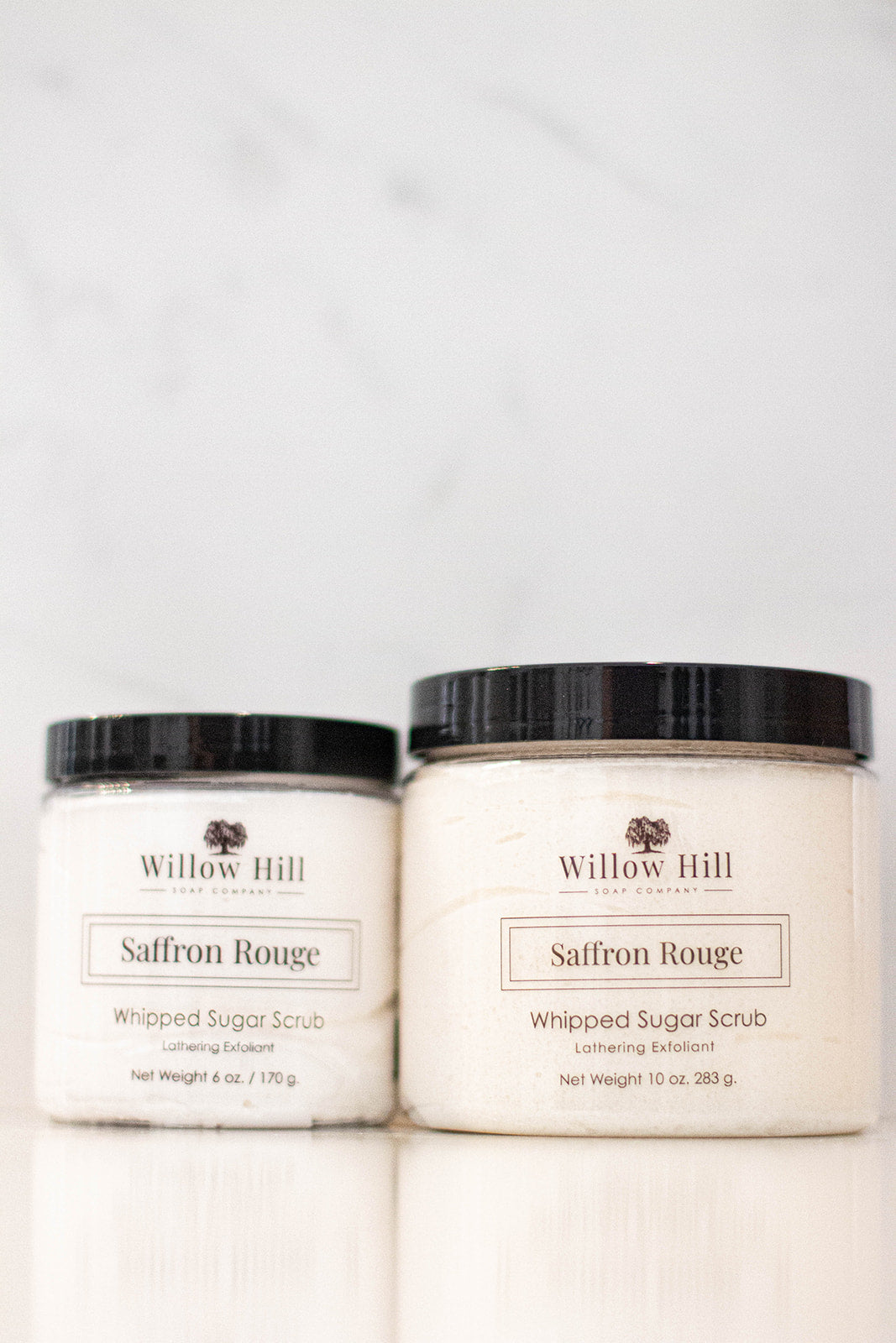 10 oz and 6 oz package of Saffron Rouge Whipped Sugar Scrub on a white background. 